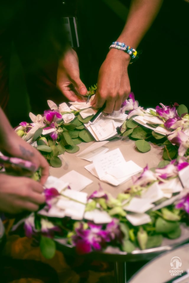 Notes being added to a wreath during Celebration Of Life ceremony on Groove Cruise