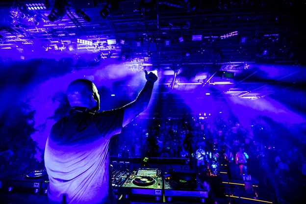 Trance DJ performing in the theater aboard EDM cruise rave