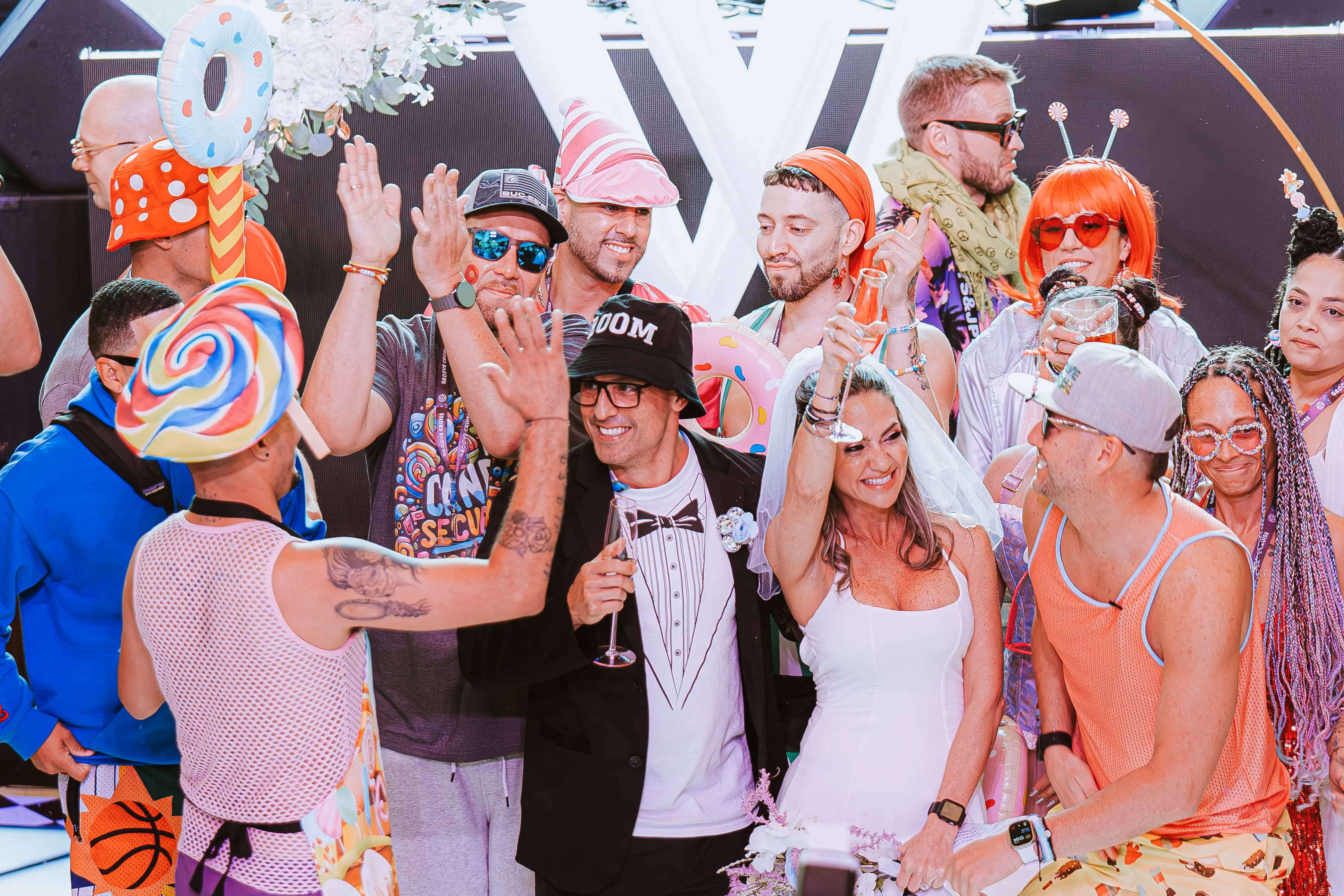 Groove Cruise bride and groom celebrating among friends at EDM festival.