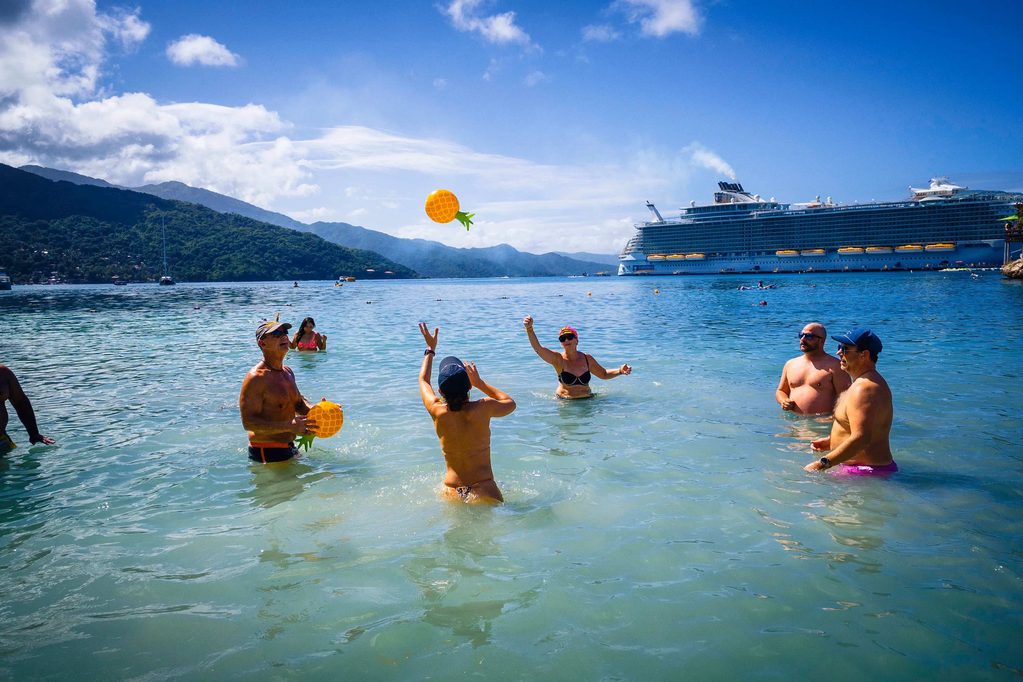 Groove Cruise captains playing volleyball in the ocean at the destination party.