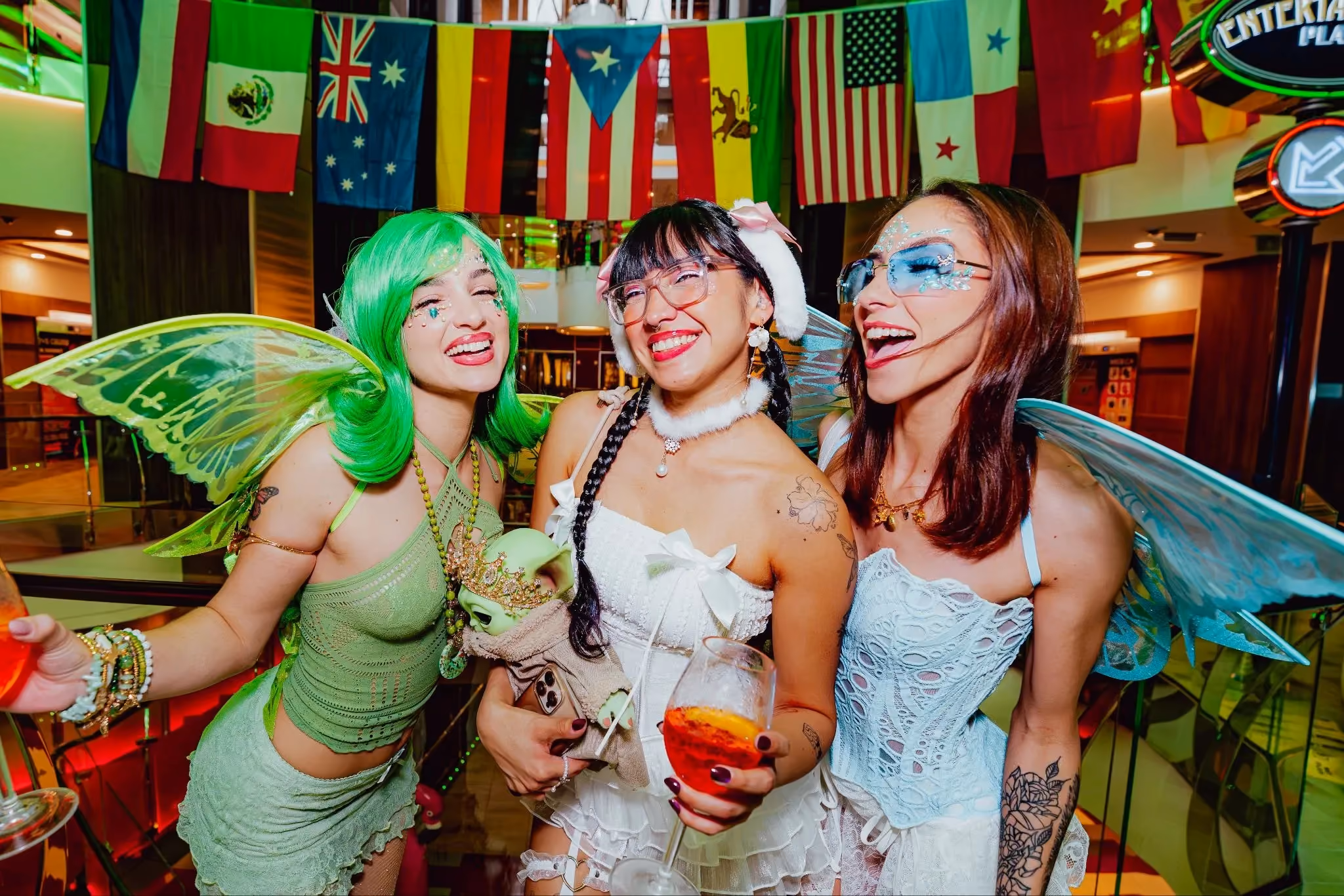 Three music festival goers wearing fairy themed rave costumes.
