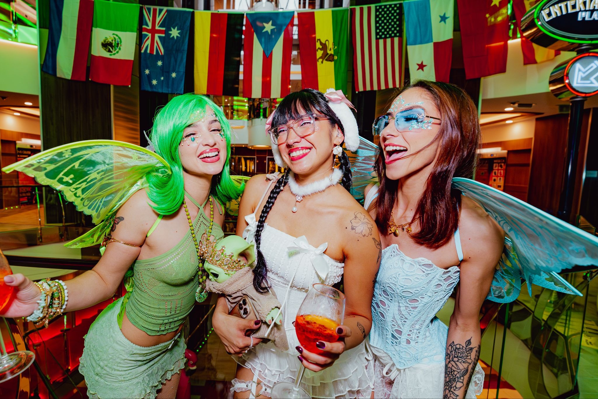 Three music festival goers wearing fairy themed rave costumes.
