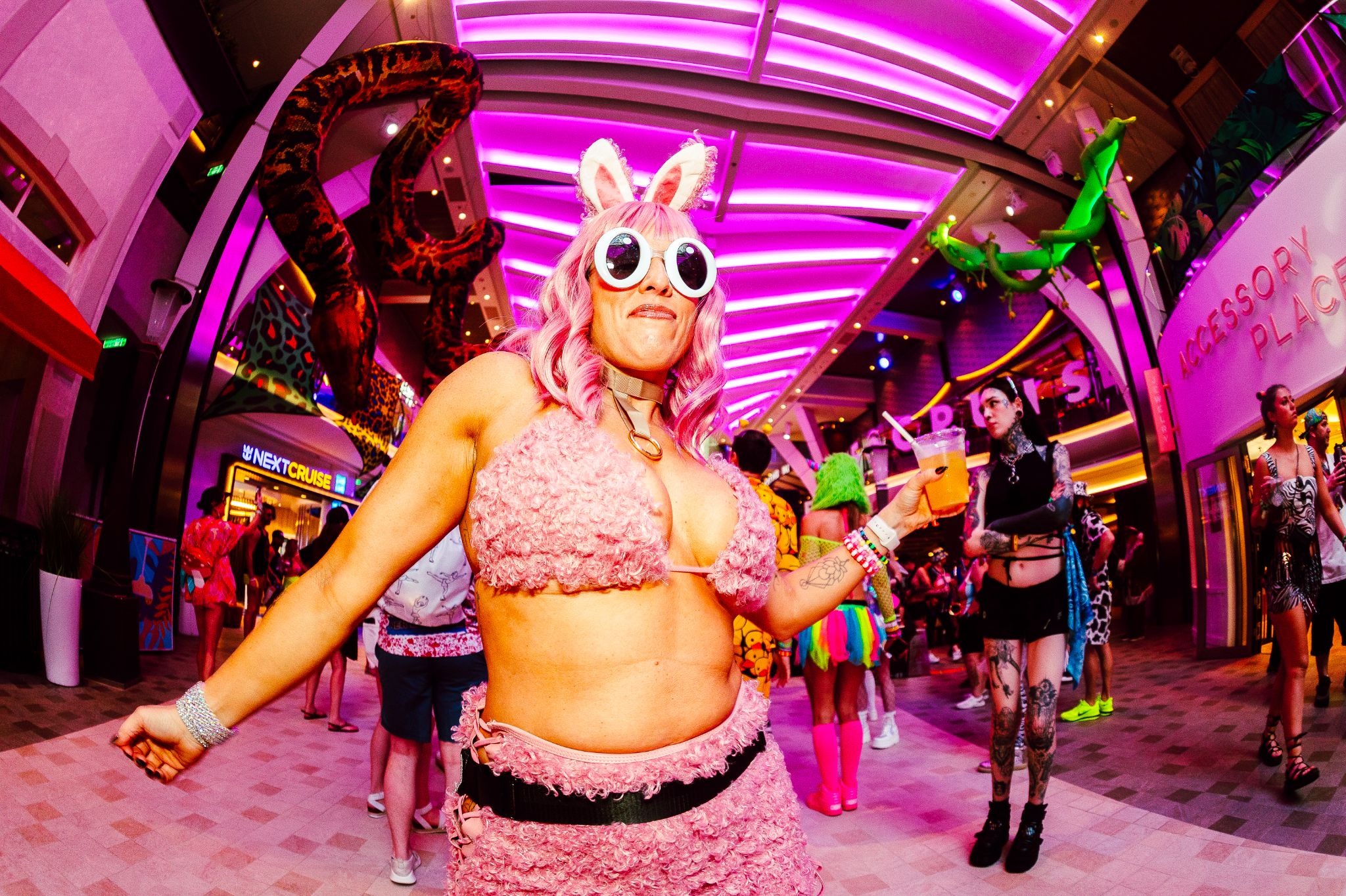 Woman wearing pink cartoon themed rave outfit EDM cruise 