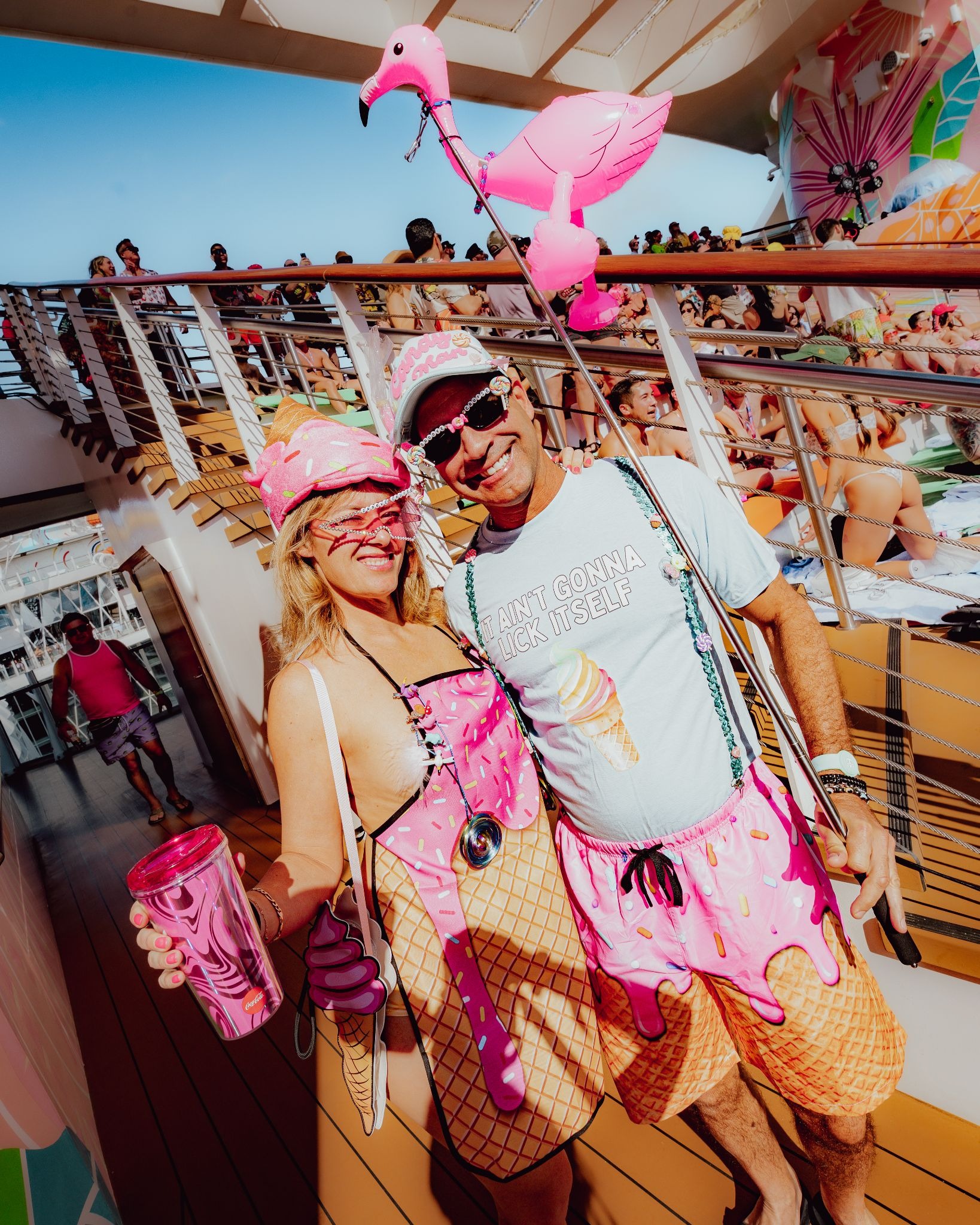 Raver couple wearing flamingo themed festival costumes on Groove Cruise