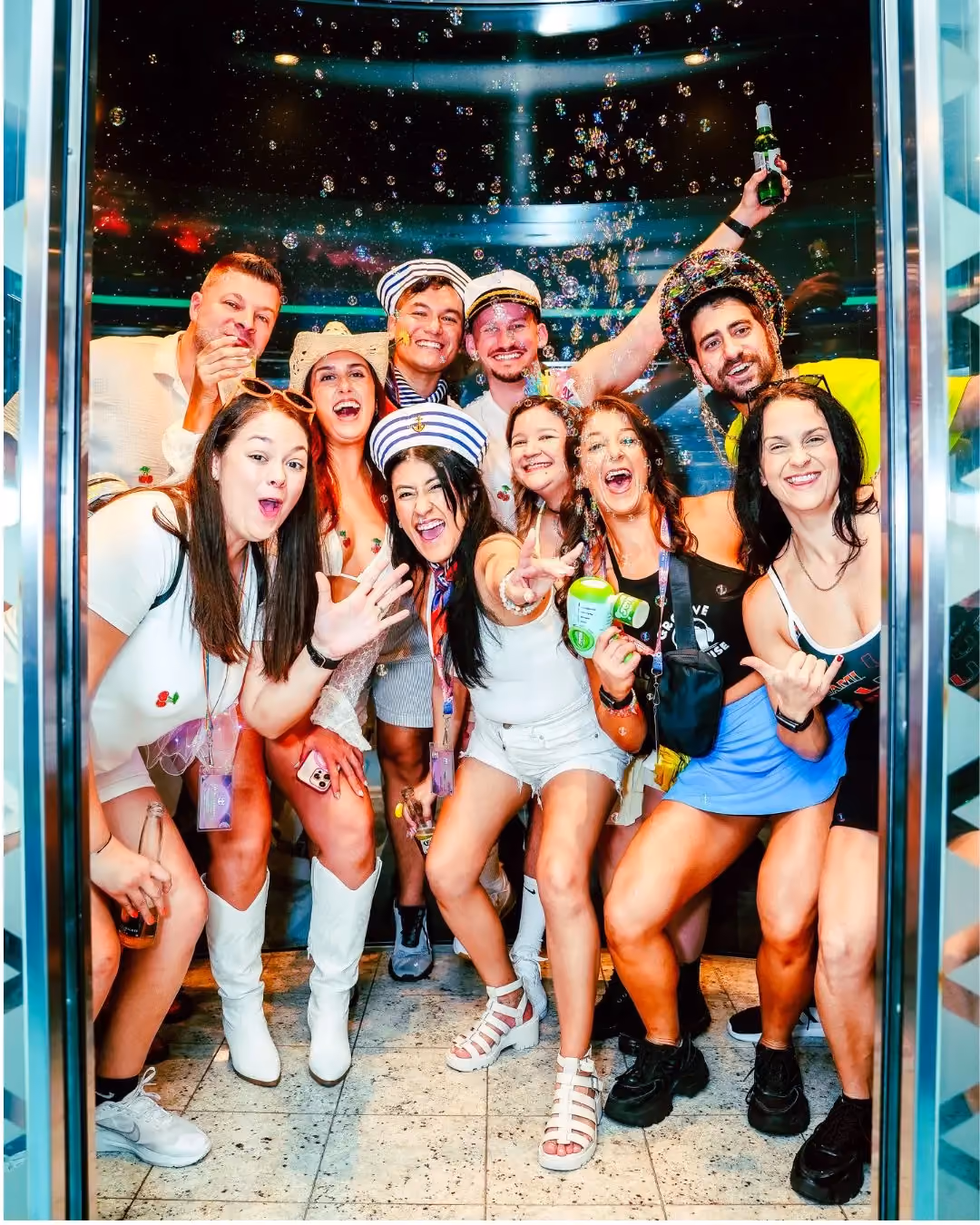 Group of friends smiling in an elevator on Miami music festival cruise
