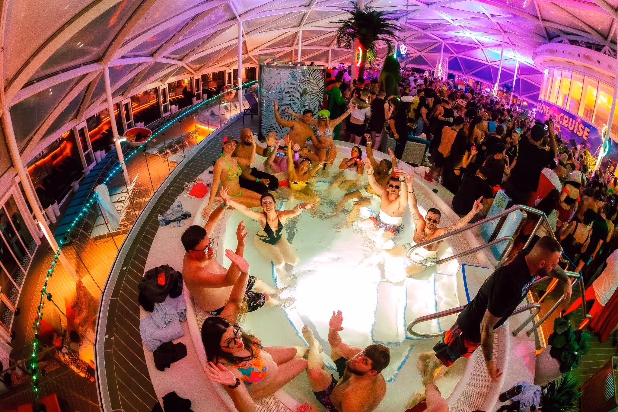 Birds-eye view of festival goers in a hot tub on a Miami rave cruise.