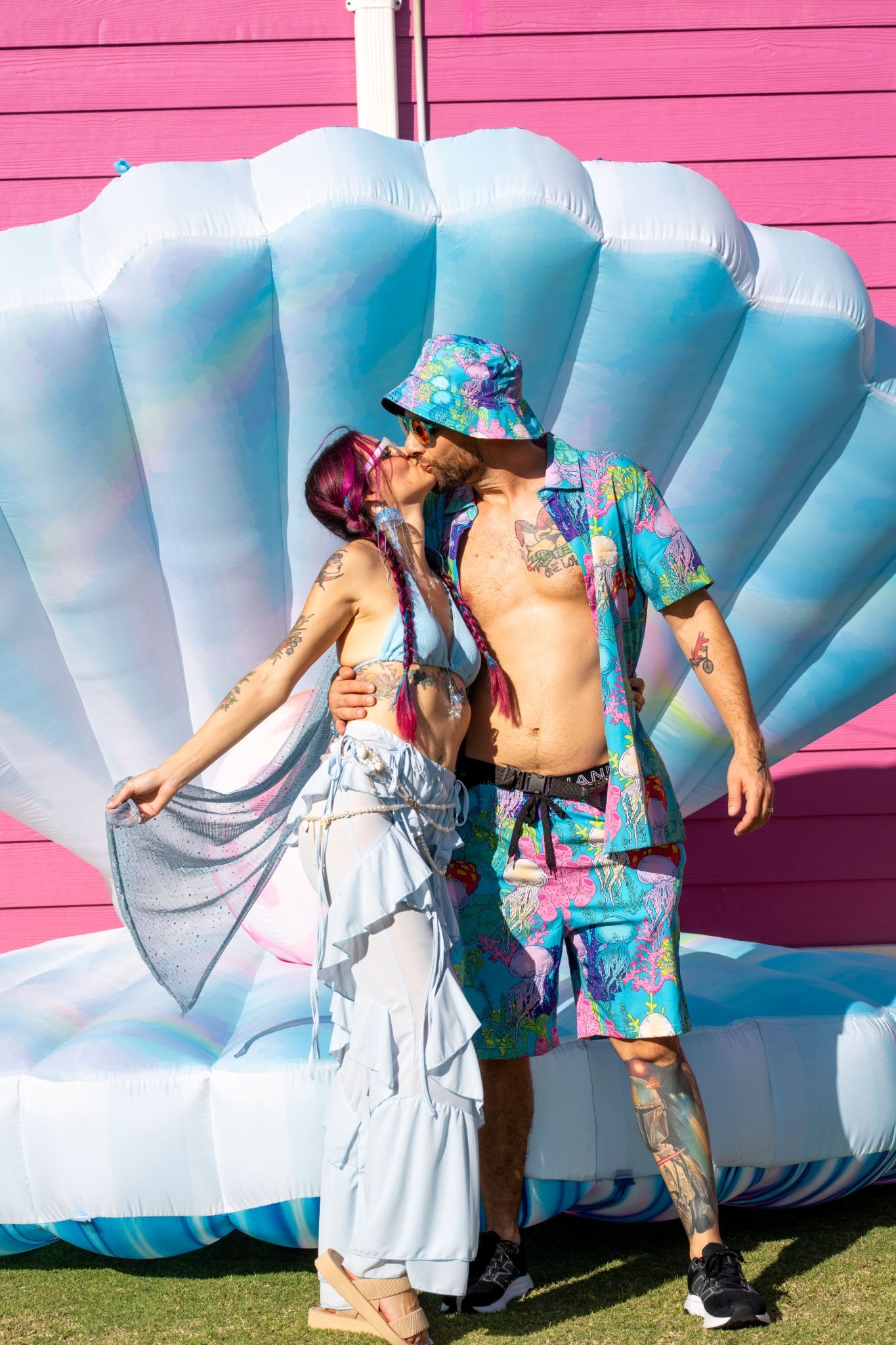 A couple kissing in themed costumes on a music festival cruise