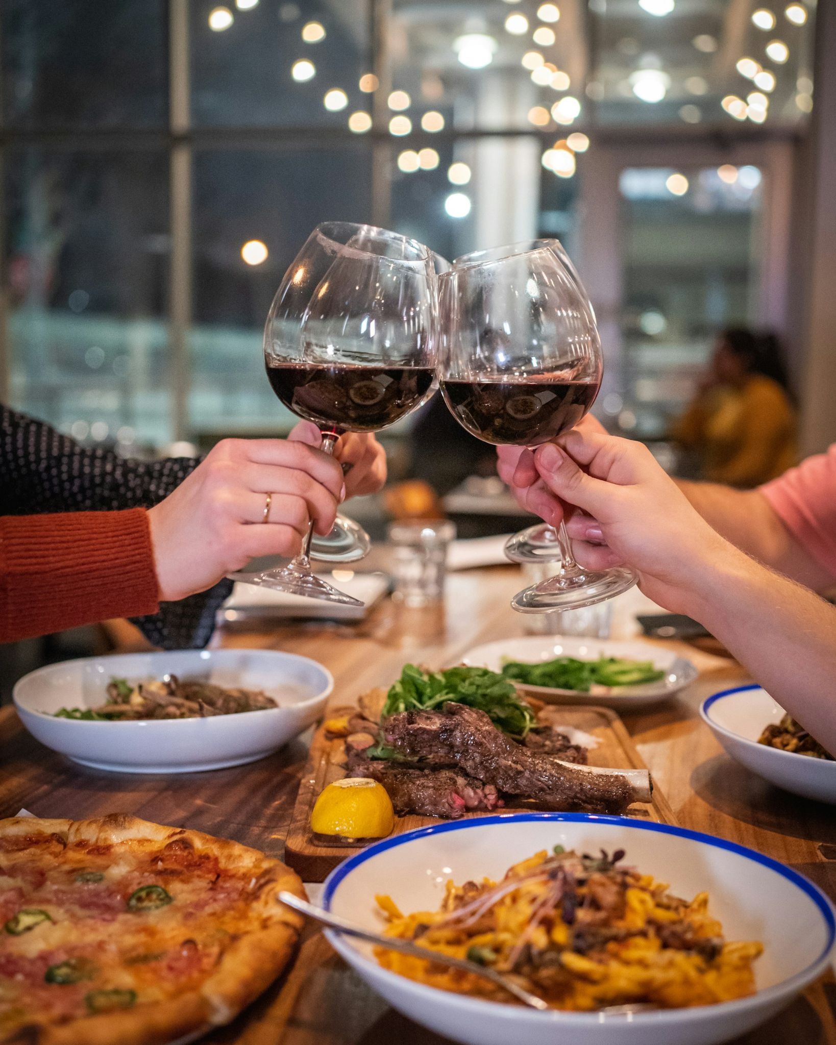 Couple toasting with wine over a romantic anniversary meal