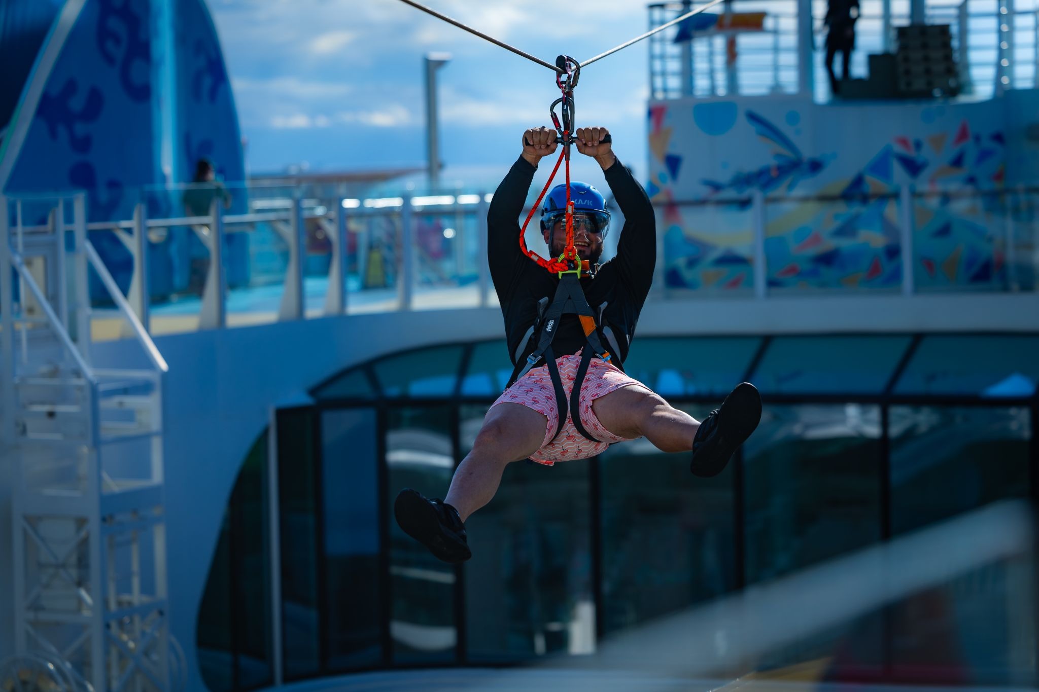 A Groove Cruise captain taking a ride on the zipline aboard a romantic cruise vacation