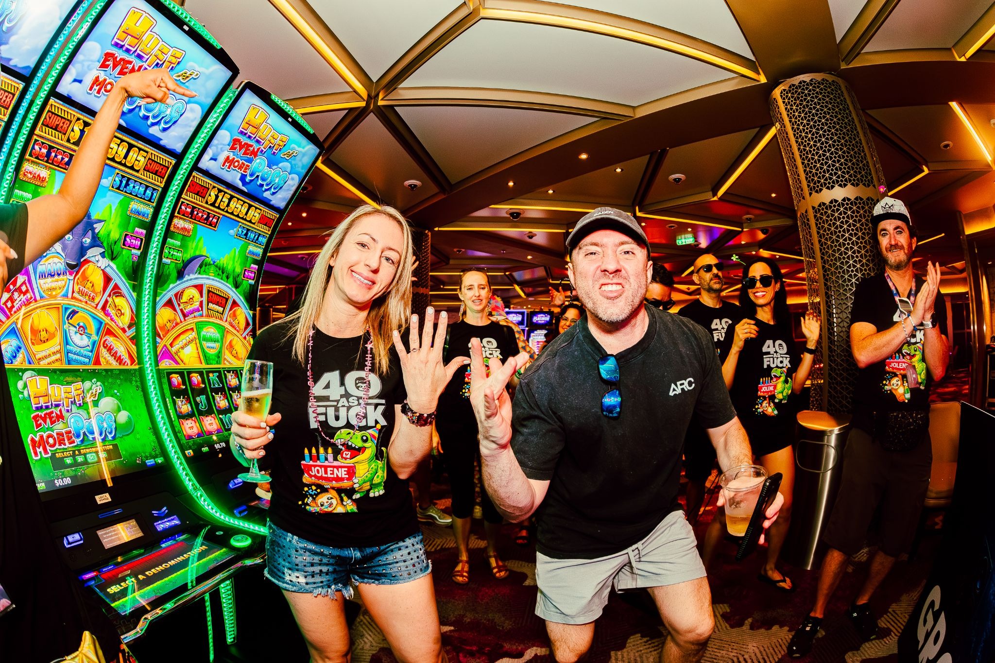 Couple showing their rings while celebrating with friends aboard Groove Cruise