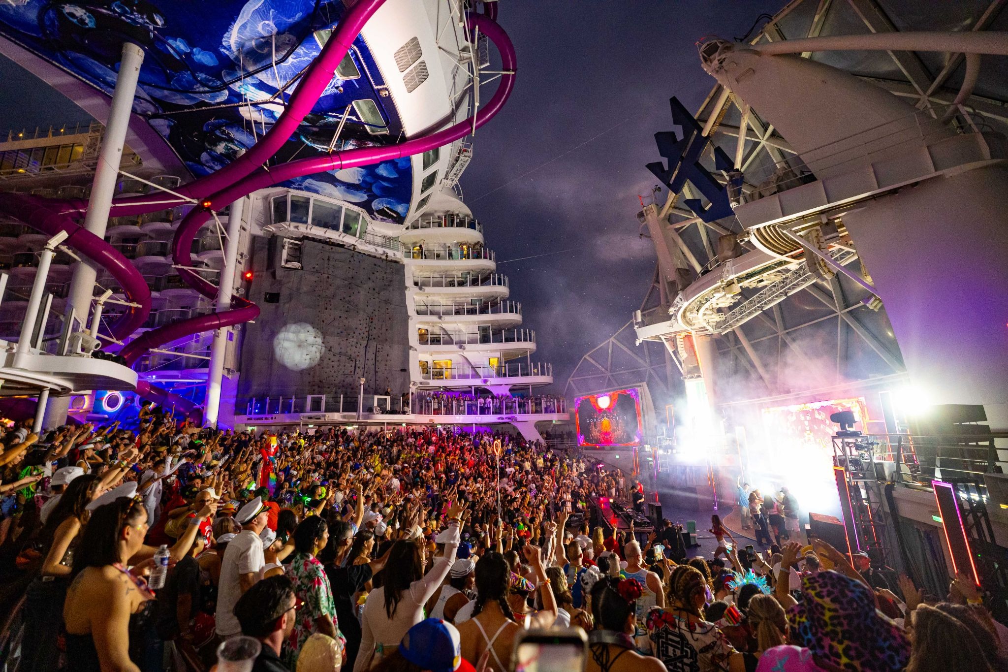 Groove Cruise 2026 crowd at a nighttime AquaTheater DJ performance 