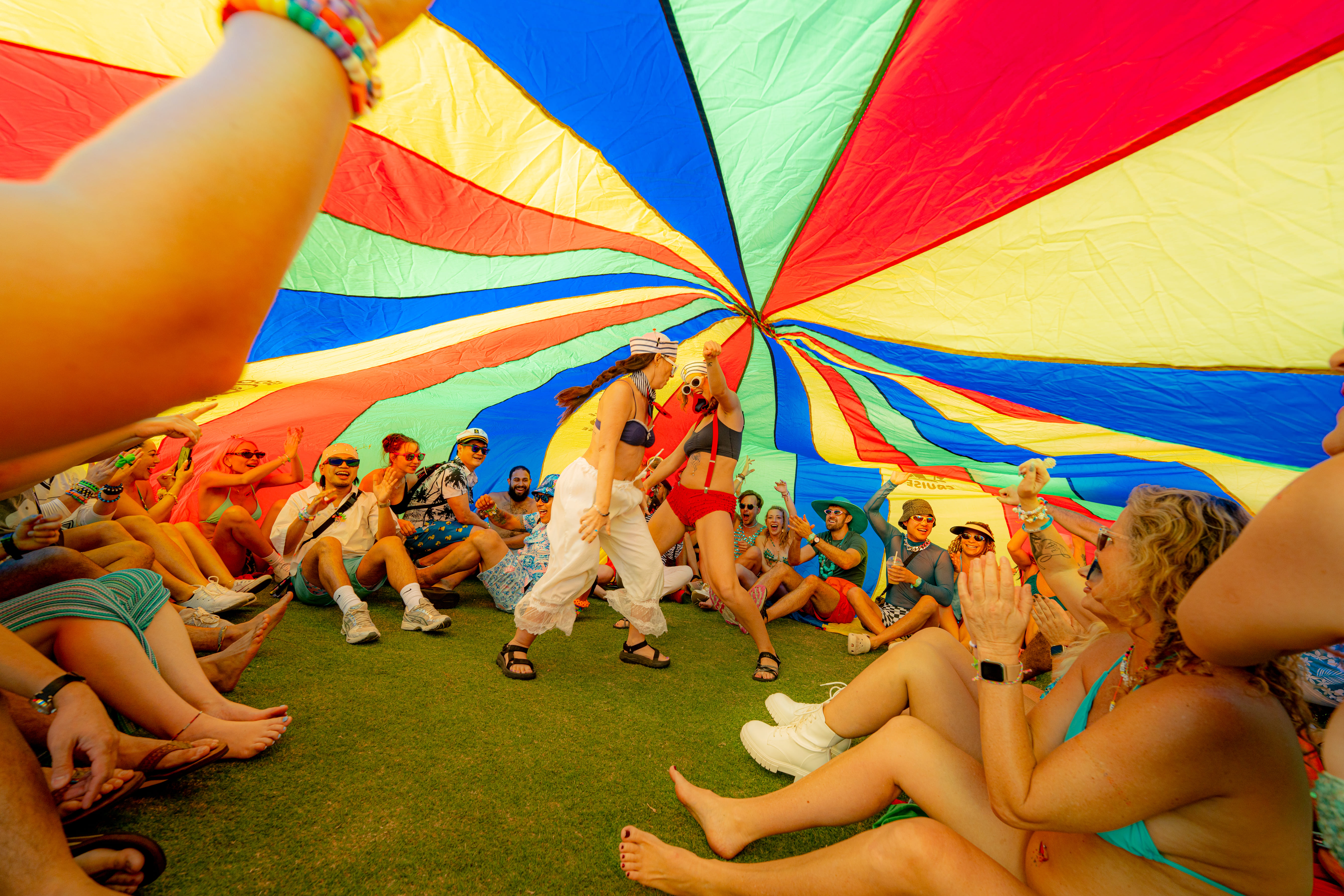 Groove Cruise Captains participating in a colorful parachute activity during a destination day
