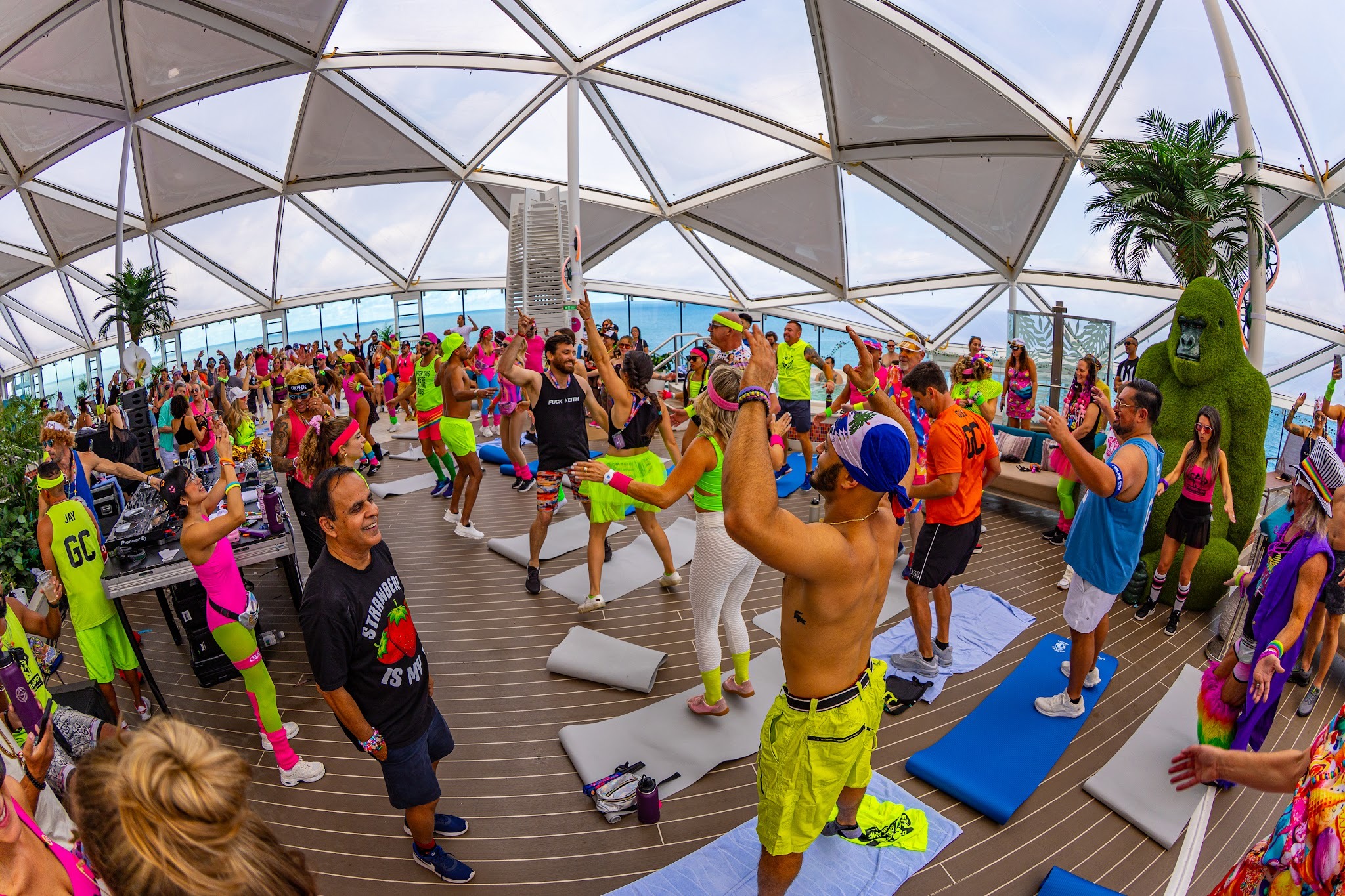Captains participating in a retro-themed fitness class on the Groove Cruise Solarium deck in 2026
