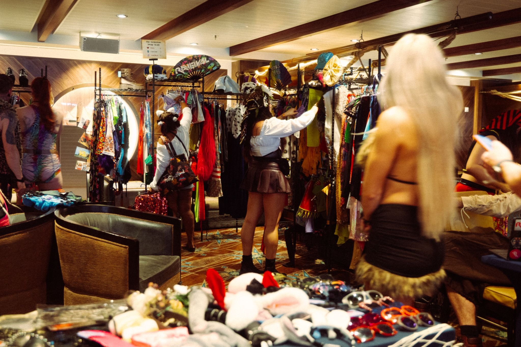 Captains browsing sustainable festival outfits at Raveival’s Treasure Hunt clothing swap on Groove Cruise
