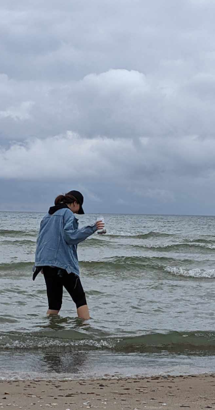 Photo of Mariah collecting rocks in a lake