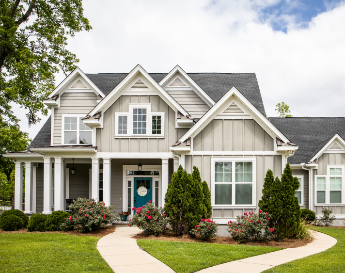 large house in sun with green grass