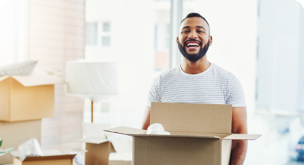 man smiling moving boxes