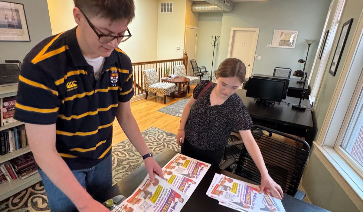 ETHS interns Tom and Mary preparing to put up flyers.
