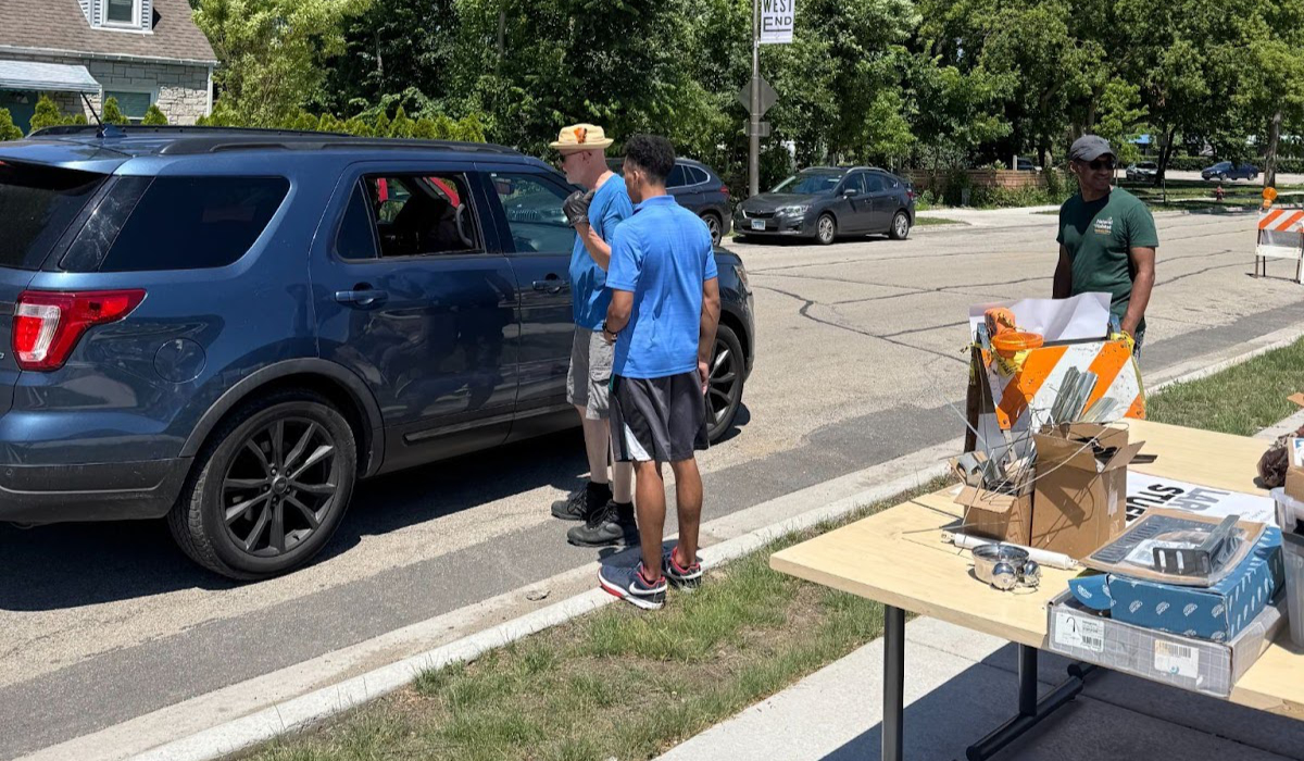 Intern Jordan helping community members at Beyond Waste's "Hard-to-Recycle" event