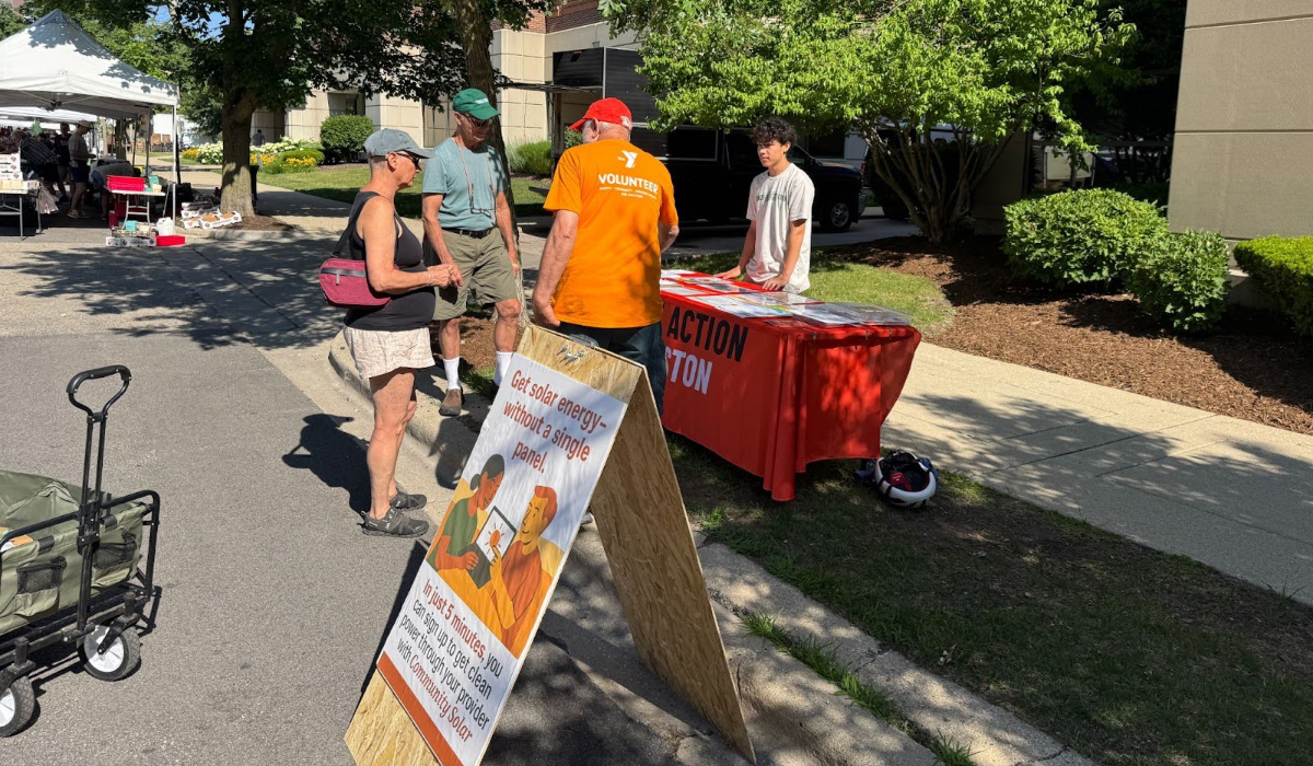 ETHS intern Jaidon encouraging people to adopt community solar at the Evanston Farmers Market