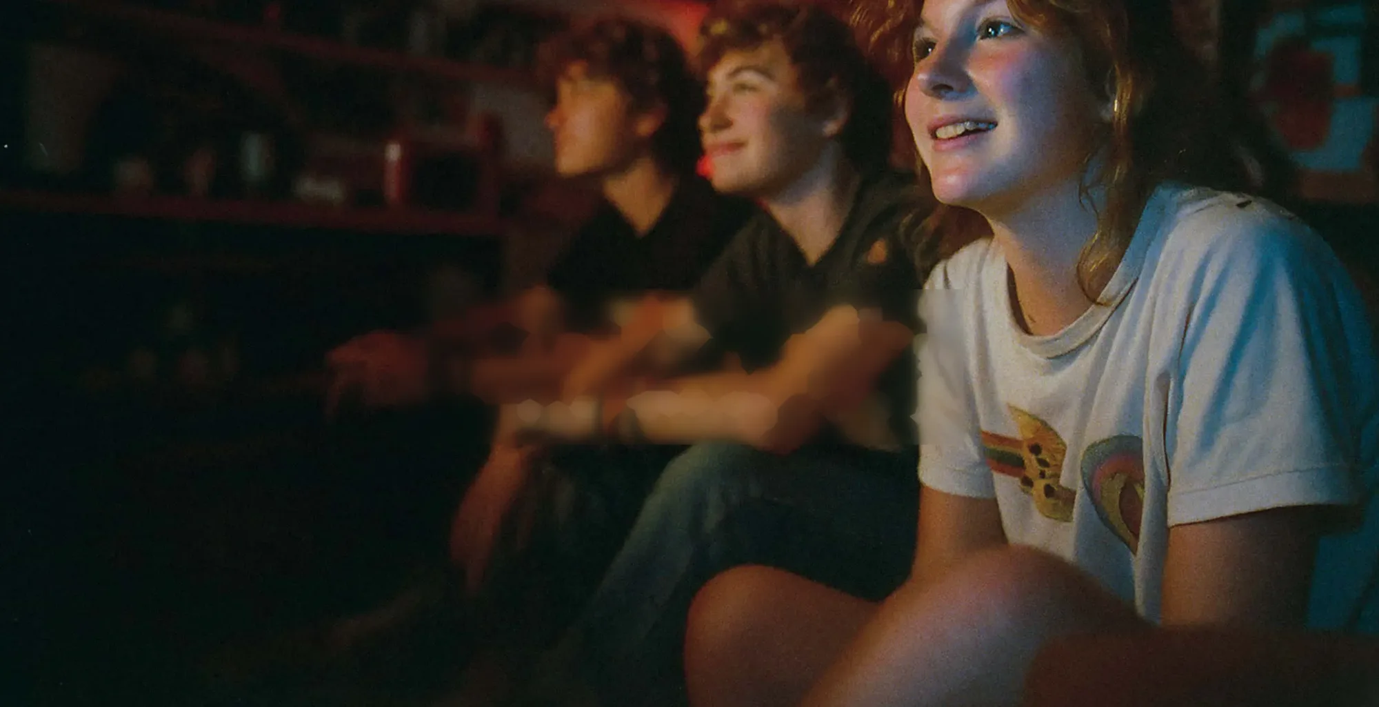 Kids smiling while watching TV together