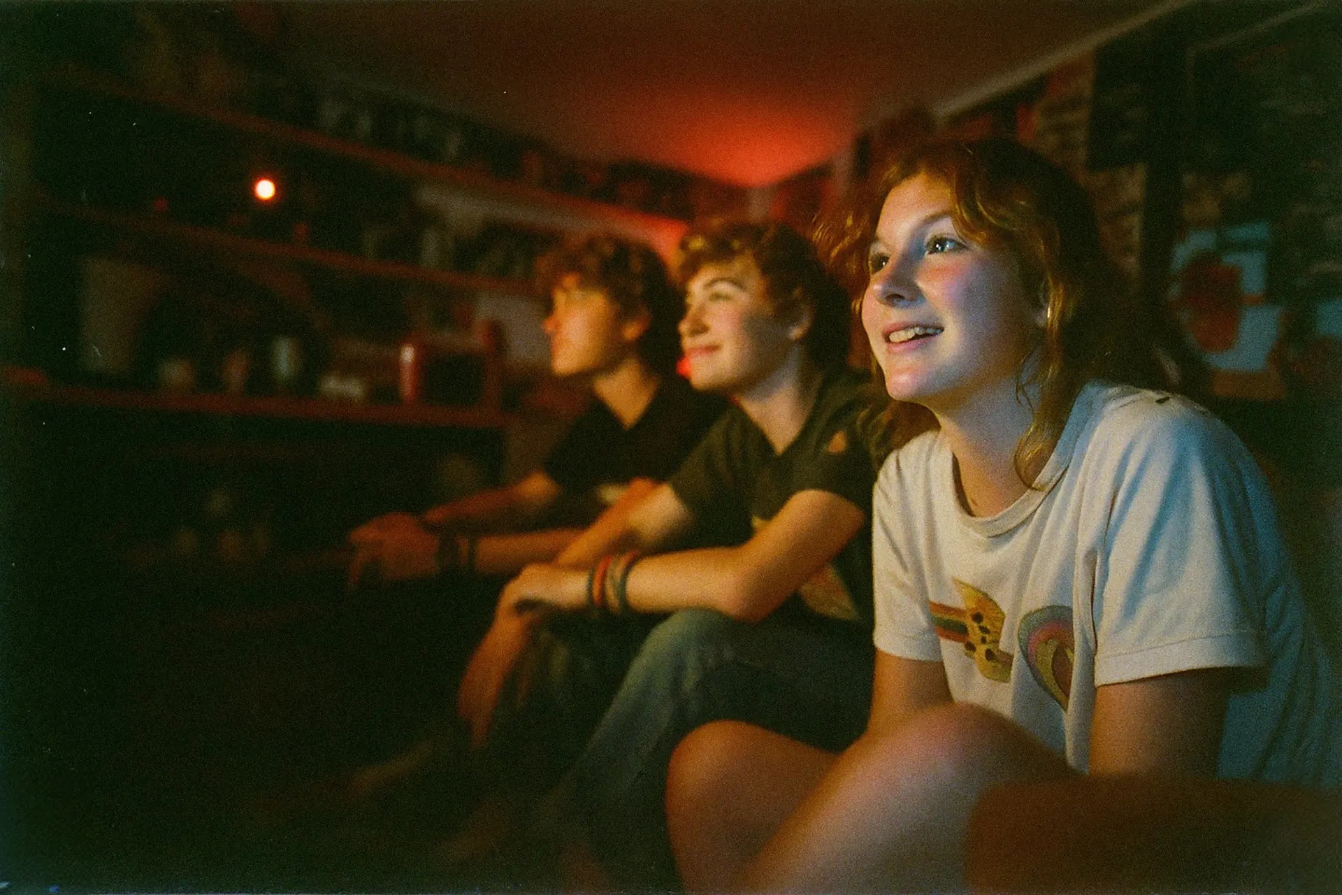 Friends watching TV together at night
