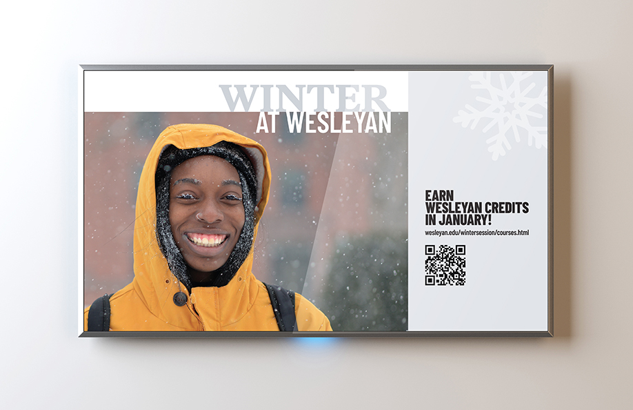A tv screen showing an ad for thee winter session at Wesleyan University