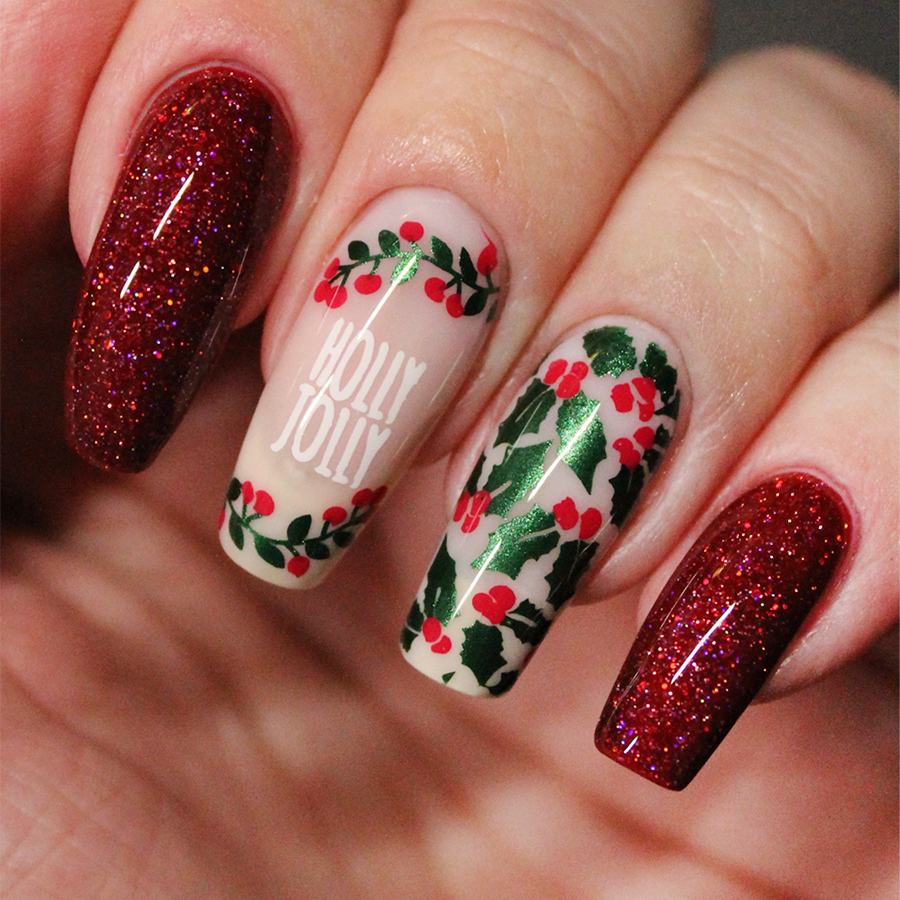 Nails painted with holly berries and nail art saying "Holly Jolly"