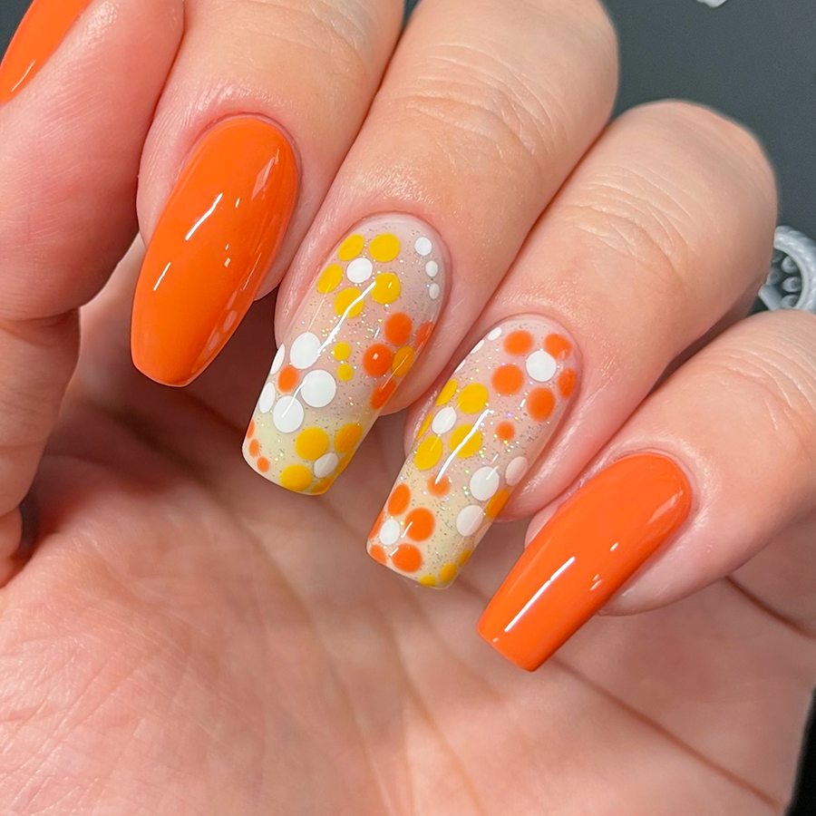 Nails painted with orange flower nail art