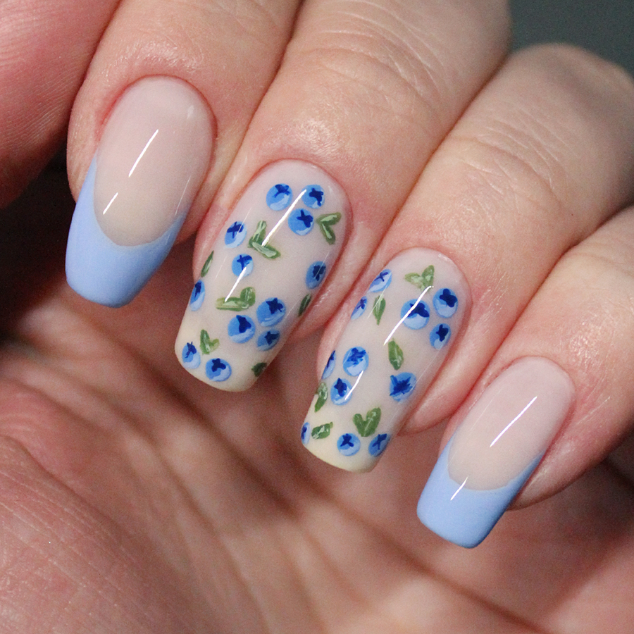 Nails painted with blueberry nail art