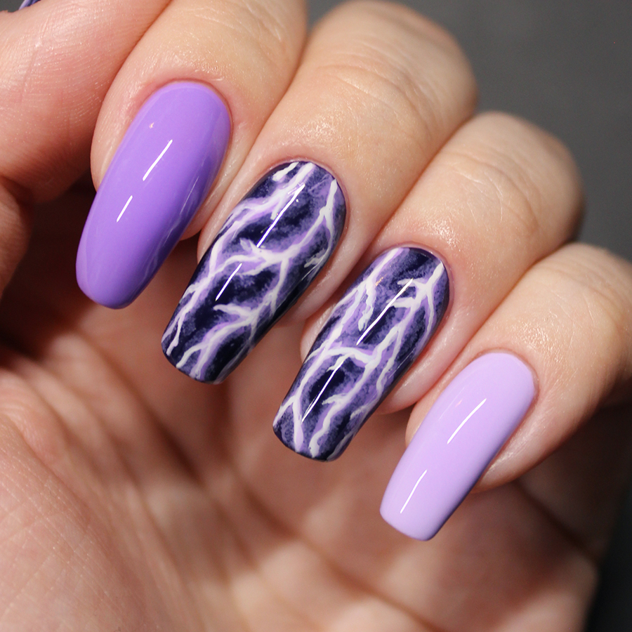 Nails painted with purple lightning nail art