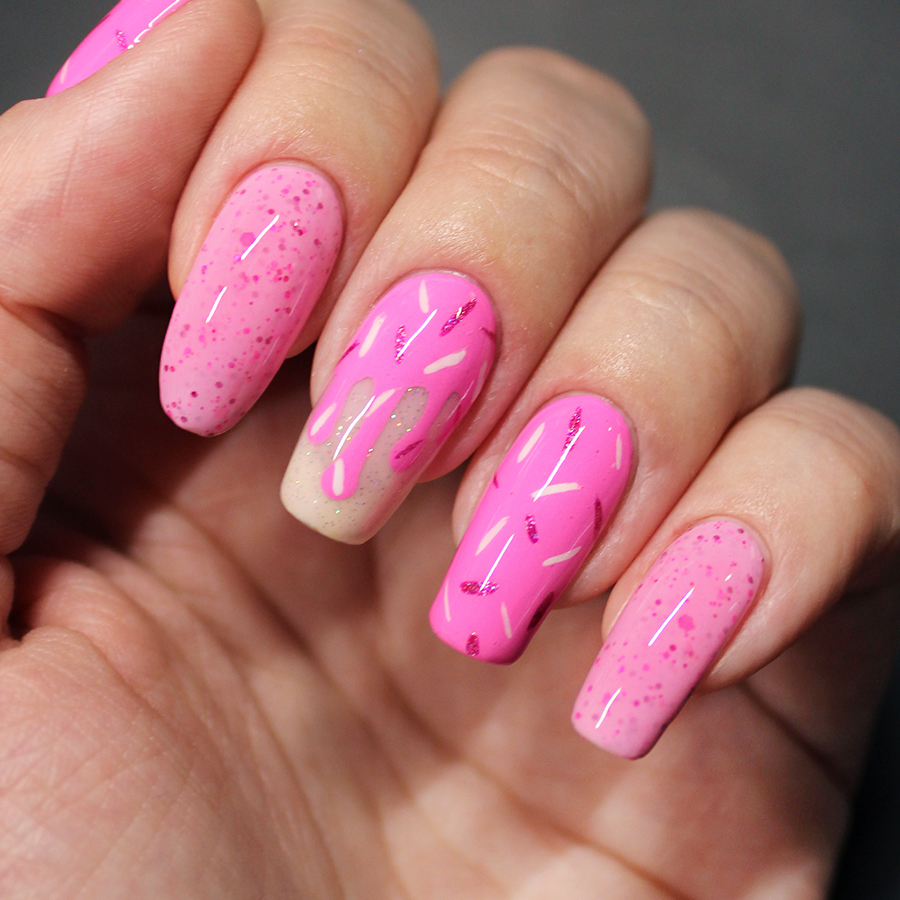 Nails painted with pink sprinkle nail art