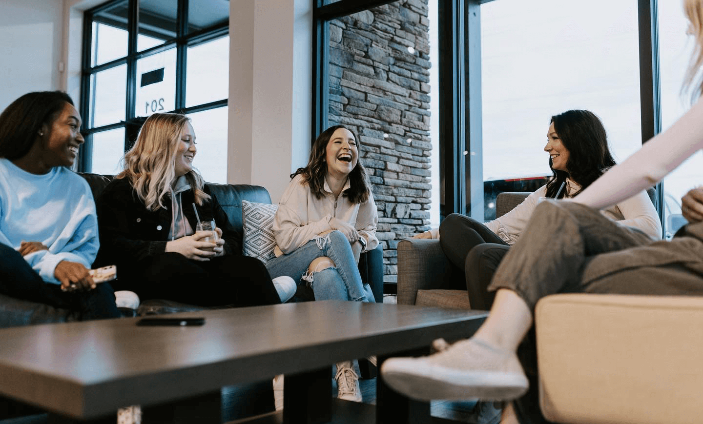 5 women sitting laughing