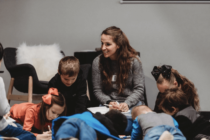 Women sitting with kids