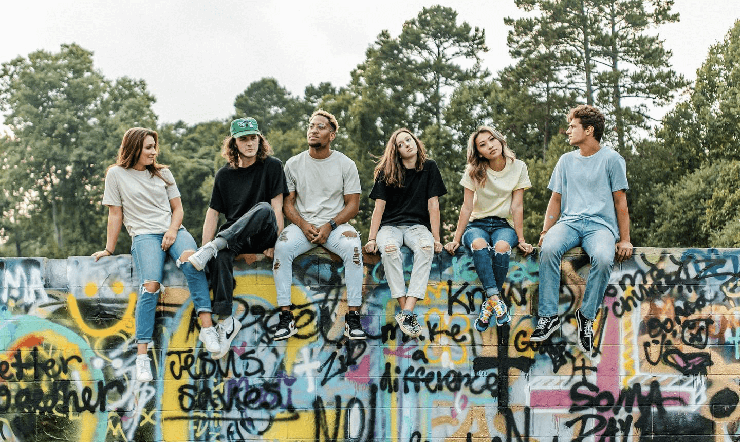 Young Adults sitting on an elevated concrete wall