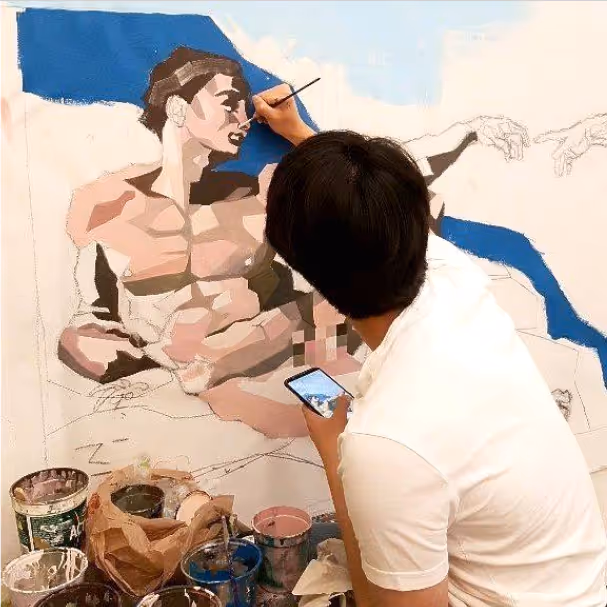 Jon C., Portfolio Program graduate, painting his rendition of "The Creation of Adam".