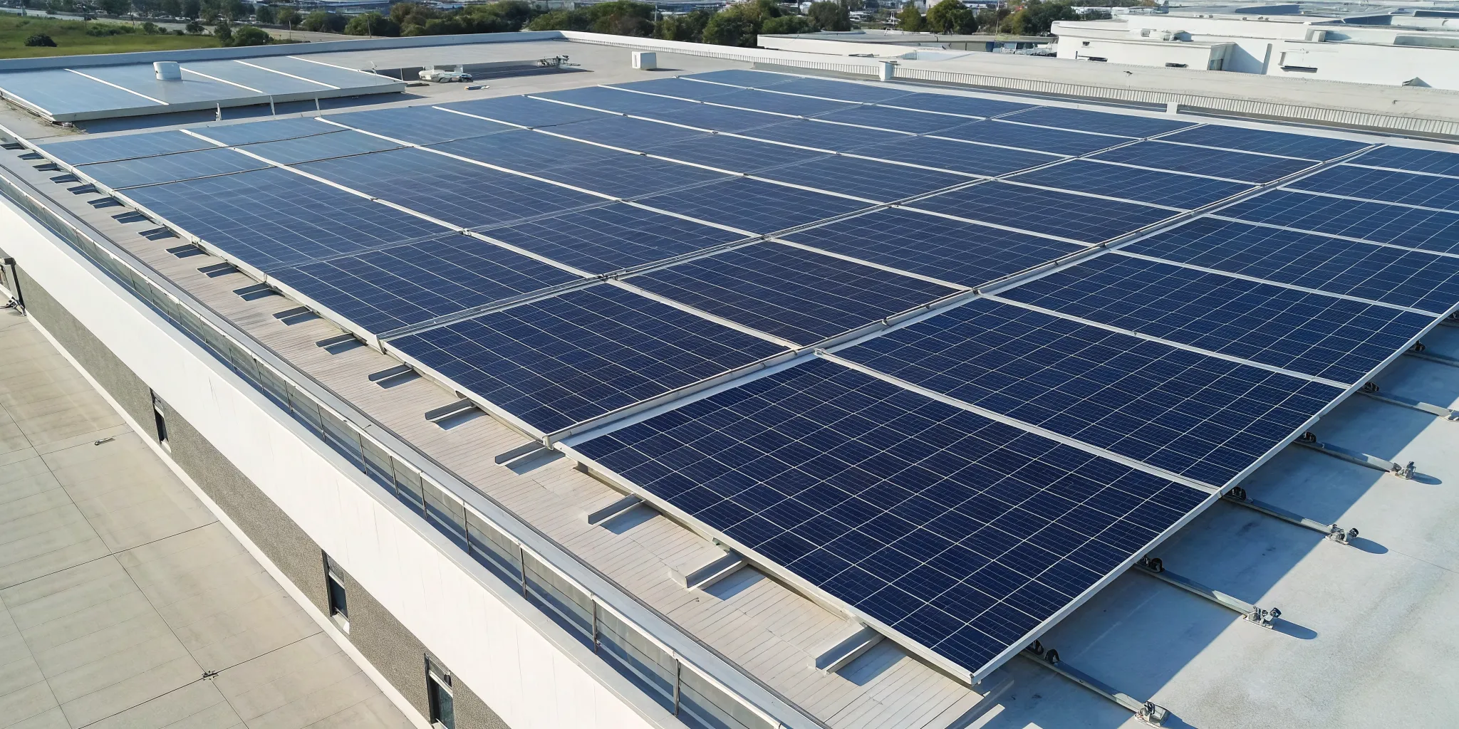 An array of commercial solar panels on a flat roof, a key factor in the cost per square foot.