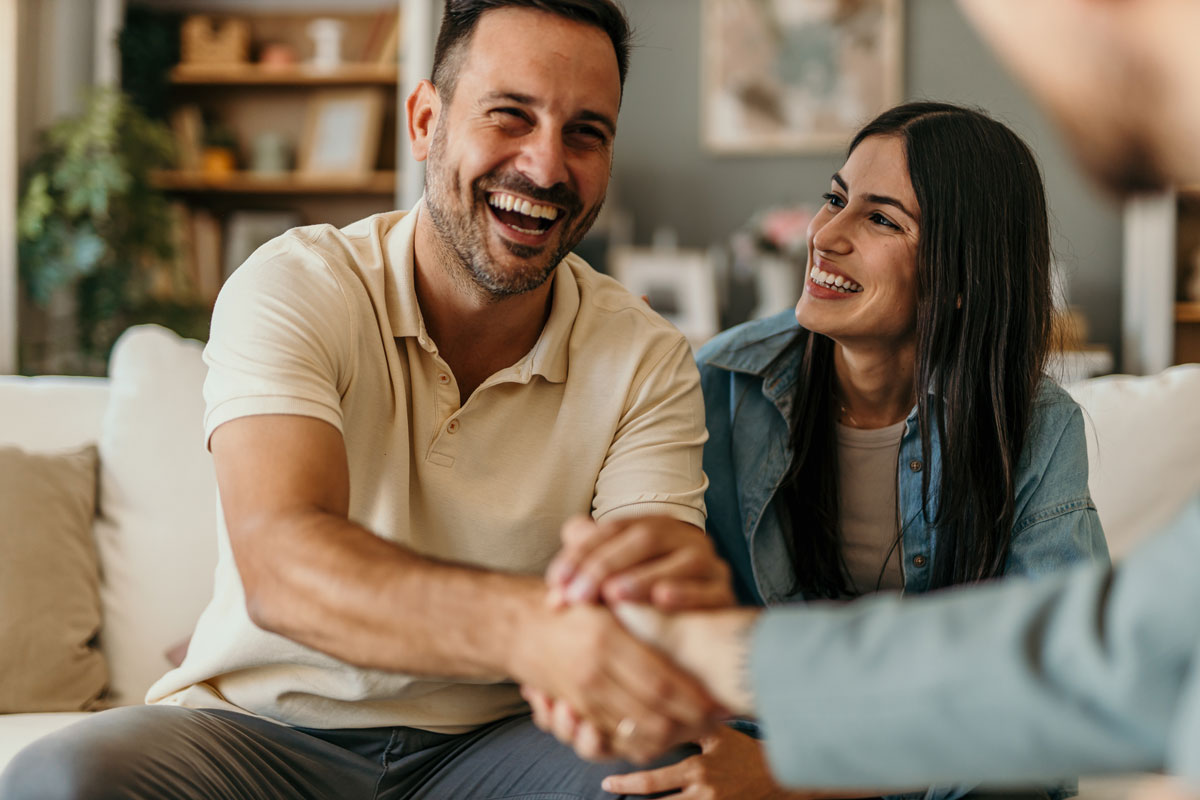 A happy couple smiling after a financial review meeting