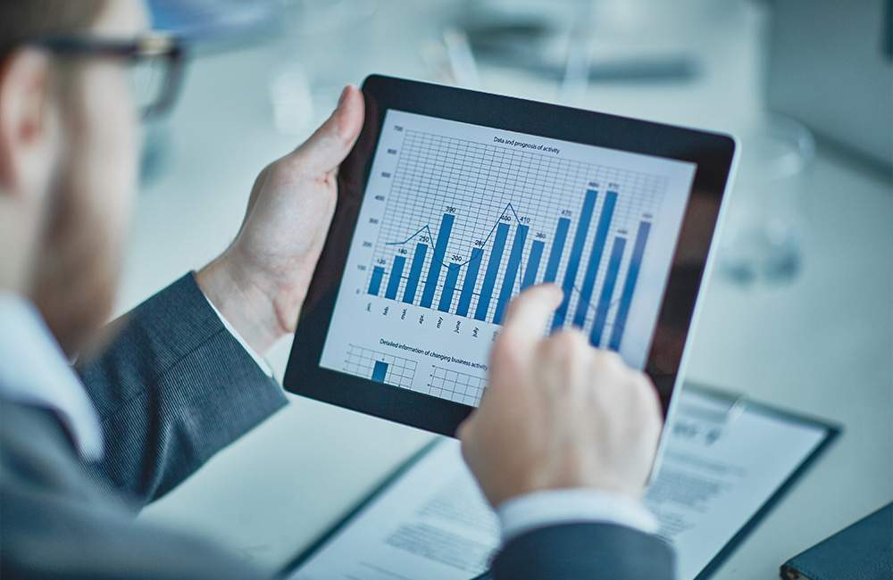 Business professional reviewing financial charts for cannabis project planning.