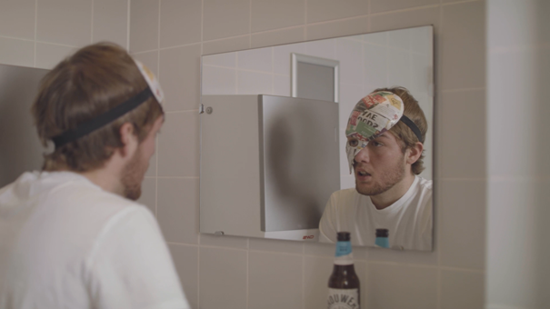 Scene from the performance, Lasse in the bathroom with a mask on