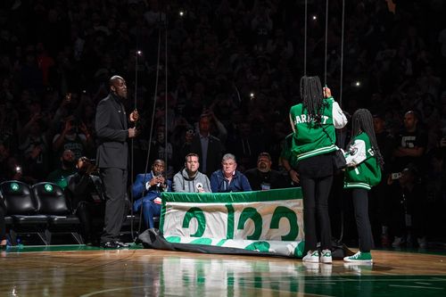 Jae taking photos during a Celtics pregame ceremony