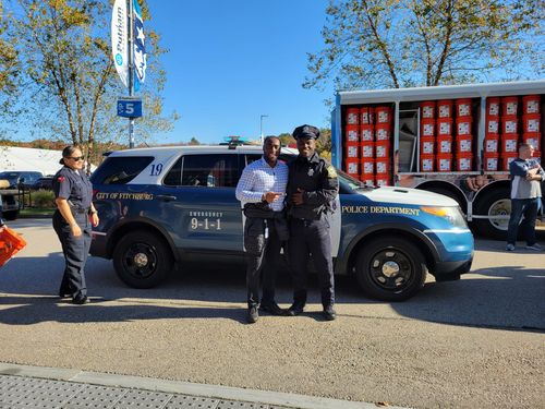 Jae with a police officer at a Patriots event