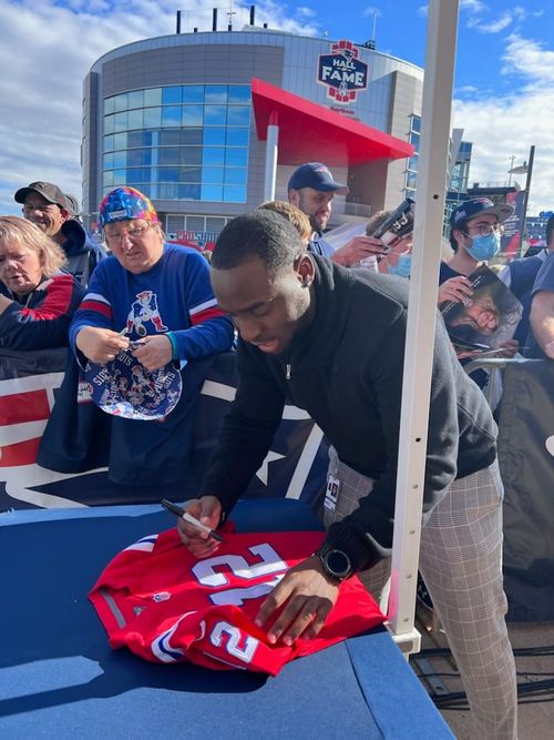 Jae signing autographs before a Patriots game