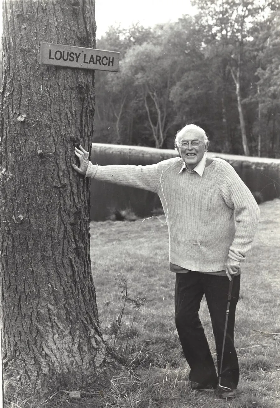 Matthew standing by a big tree
