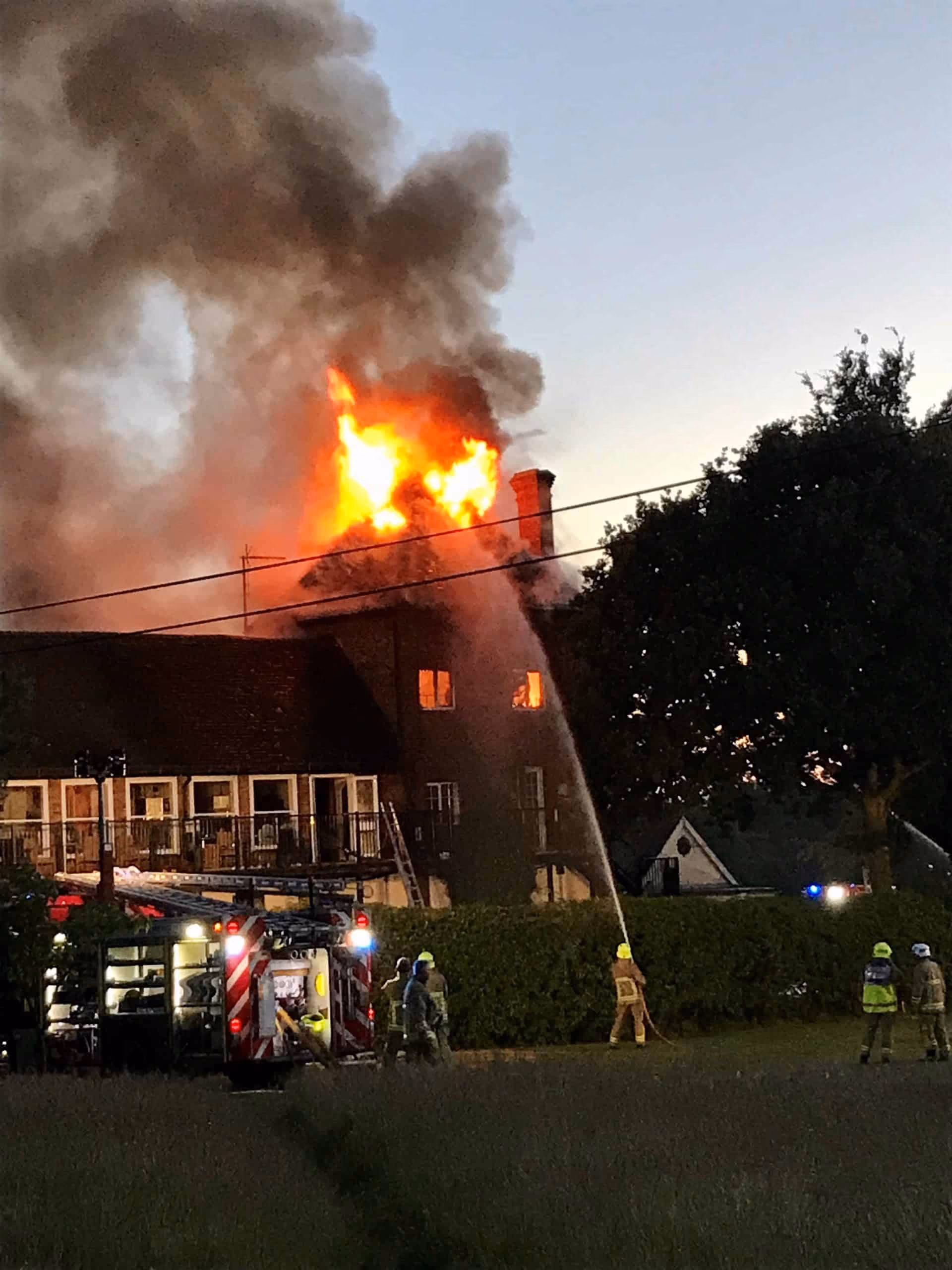 Devastating fire being put out by firefighters 