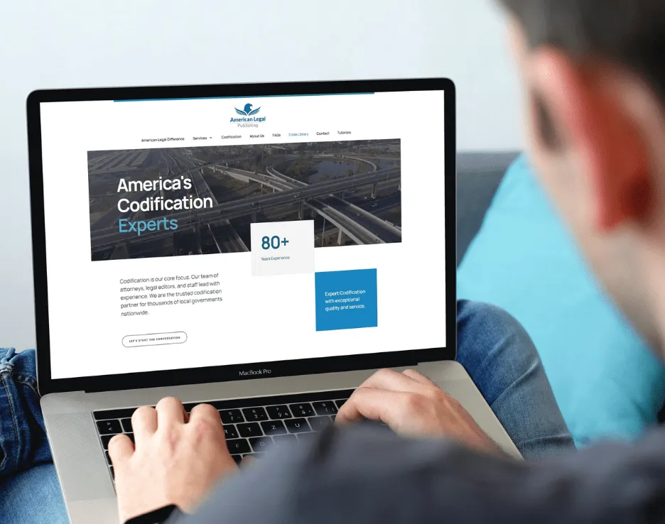 Someone using their laptop to view the AM Legal site