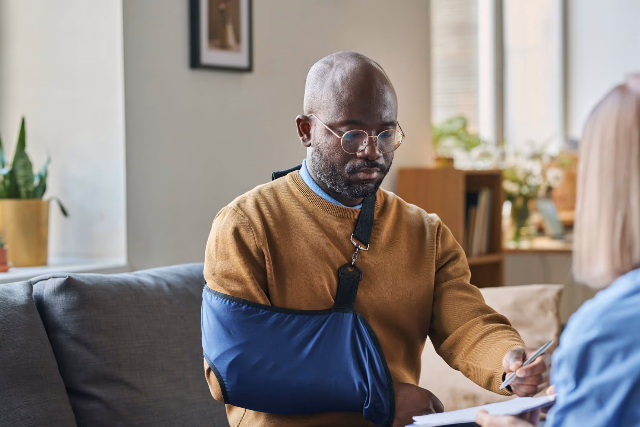 An injured man signing documents with a Kissimmee personal injury attorney.