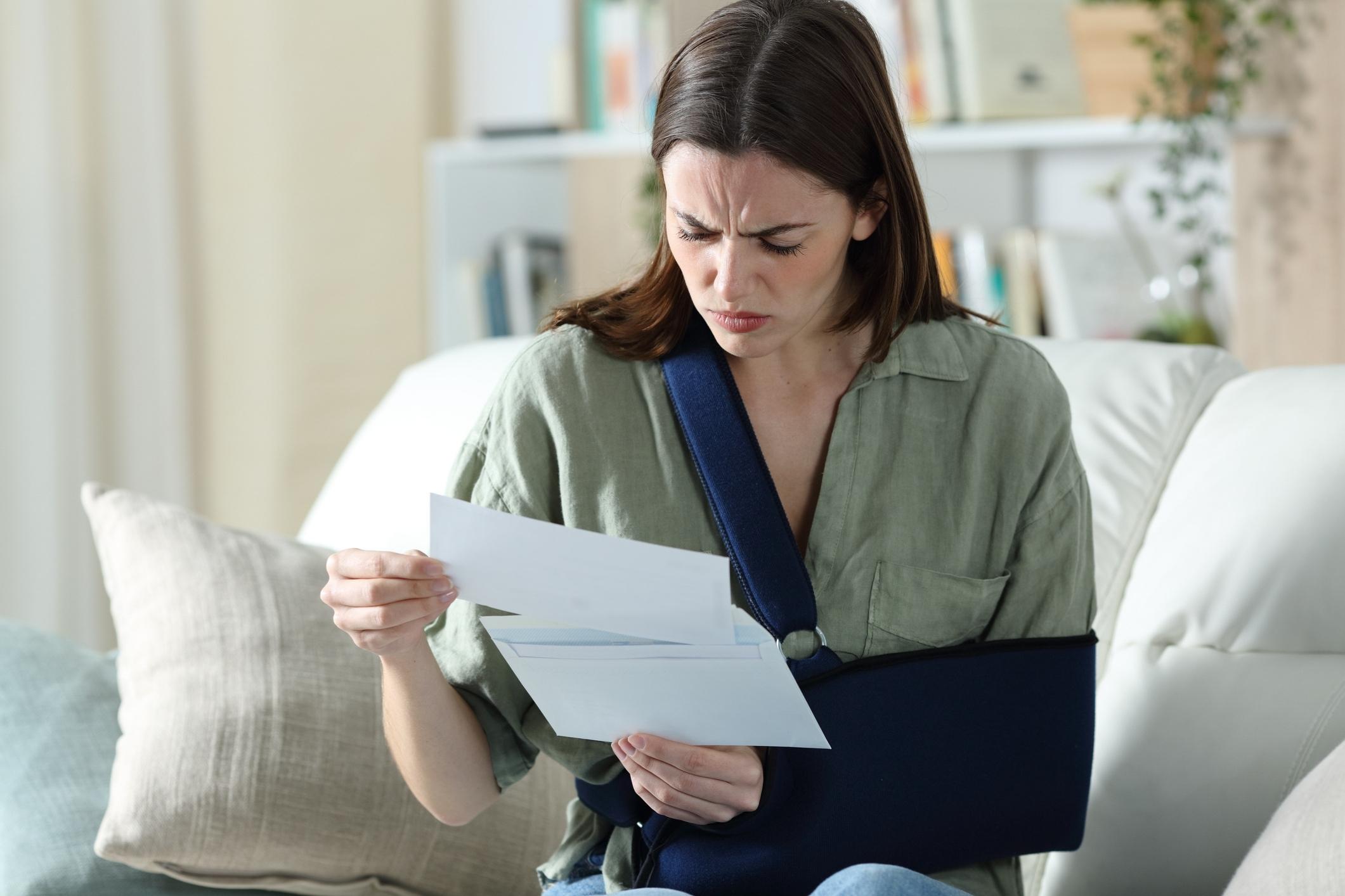 A woman reading paperwork at home after an accident, representing the need for an Altamonte Springs personal injury lawyer.
