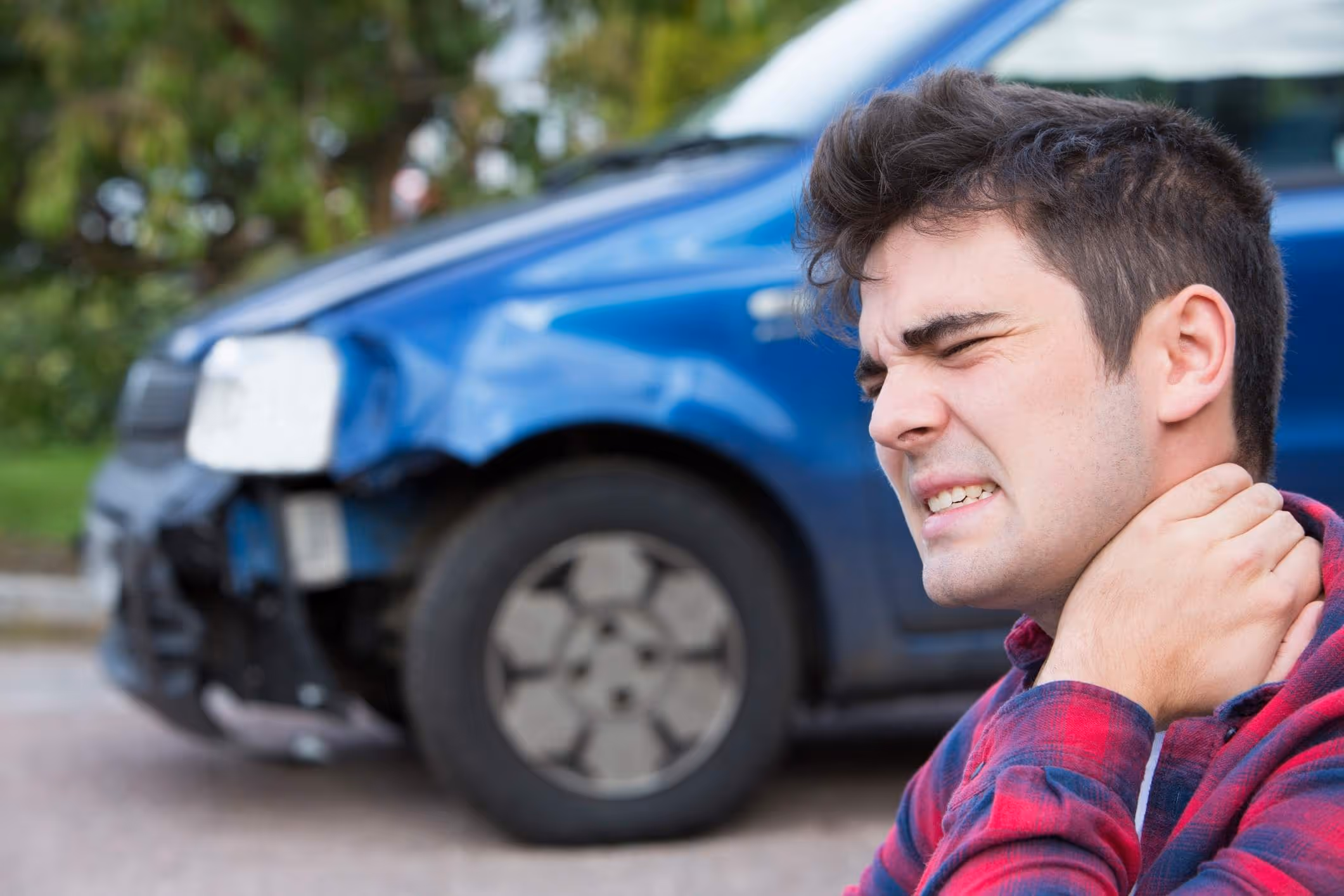 Man holding his neck in pain after crash, highlighting need for Apopka car accident attorney.