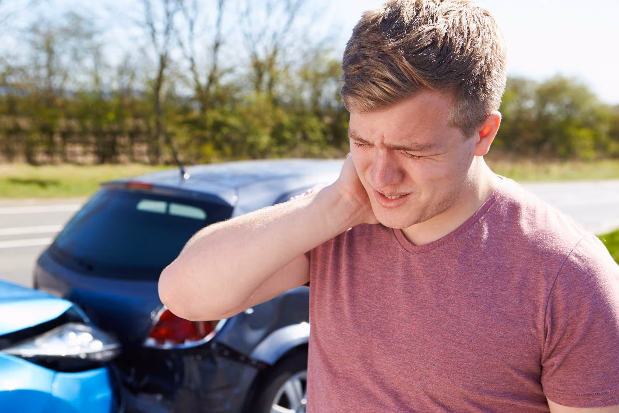 Driver in pain after a collision, representing when to contact an Oviedo car accident lawyer.